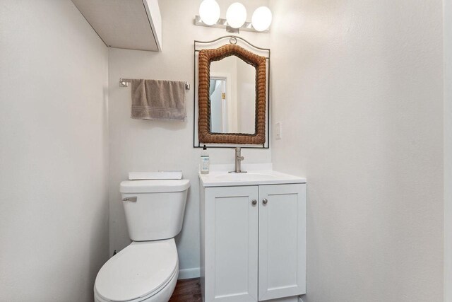 bathroom featuring toilet and vanity