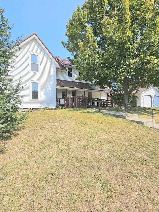 exterior space with an outbuilding, a front yard, and a garage