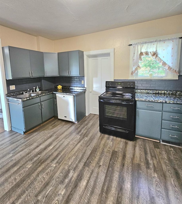 kitchen with a textured ceiling, dishwasher, black electric range oven, and dark hardwood / wood-style floors