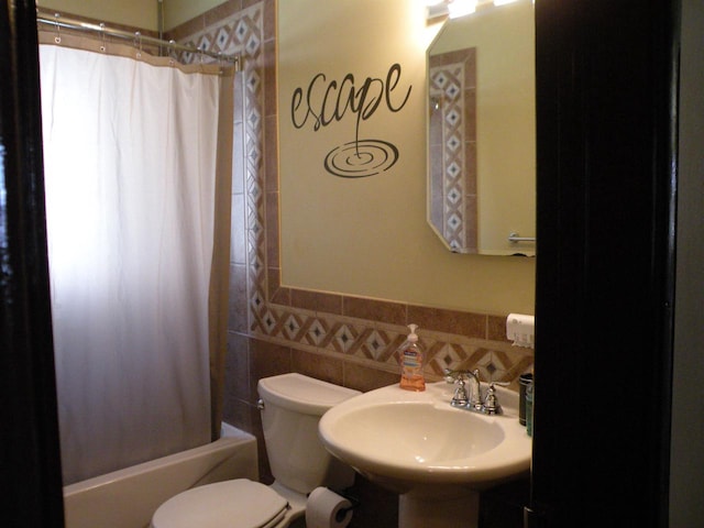 full bathroom with toilet, tasteful backsplash, sink, tile walls, and shower / bath combination with curtain