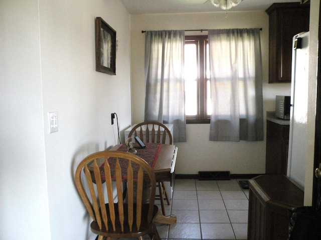 dining space featuring light tile patterned flooring