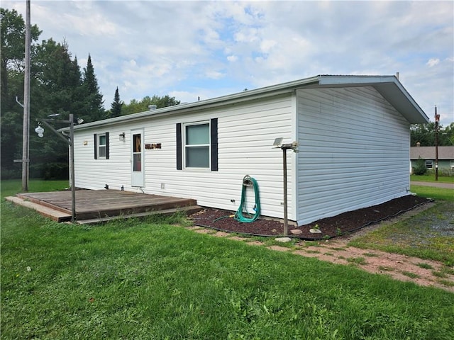 exterior space featuring a lawn and a deck