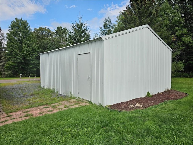 view of outbuilding featuring a lawn