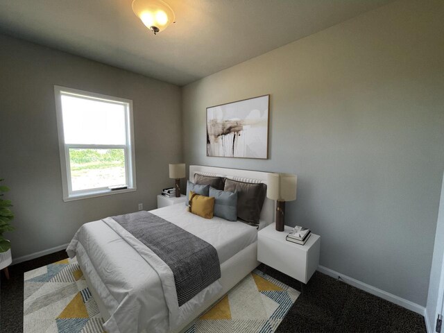 bedroom with dark colored carpet