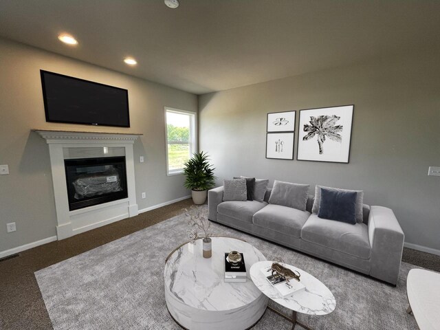 living room featuring an inviting chandelier and dark colored carpet