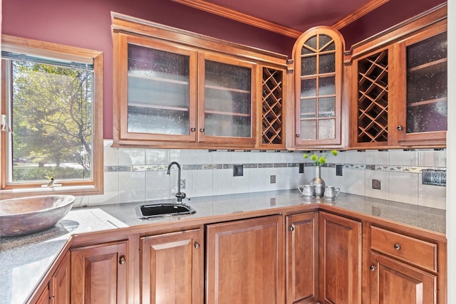 kitchen featuring ornamental molding, tasteful backsplash, and sink