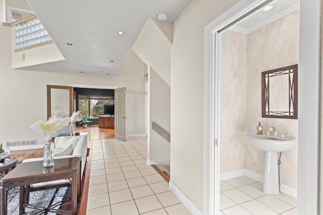 corridor featuring light tile patterned floors