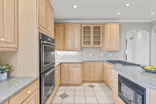 kitchen with tasteful backsplash, black appliances, light brown cabinets, light tile patterned floors, and crown molding