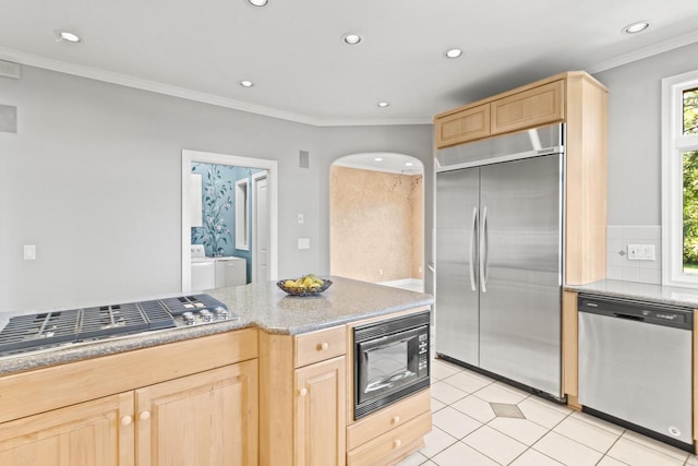 kitchen with light brown cabinetry, built in appliances, and ornamental molding