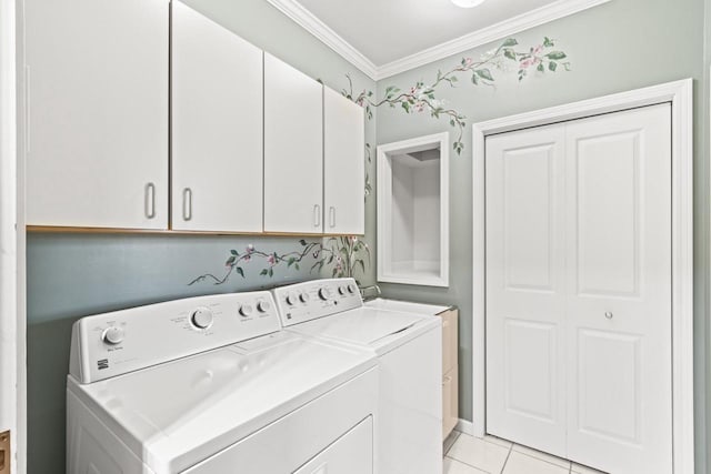 laundry area featuring washer and clothes dryer, crown molding, light tile patterned floors, and cabinets