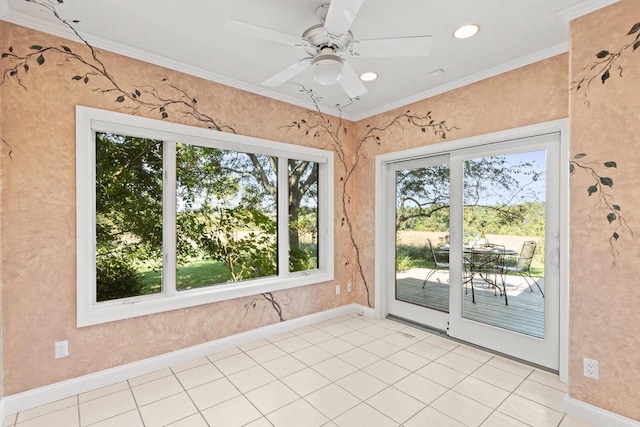 spare room featuring crown molding, light tile patterned floors, and ceiling fan