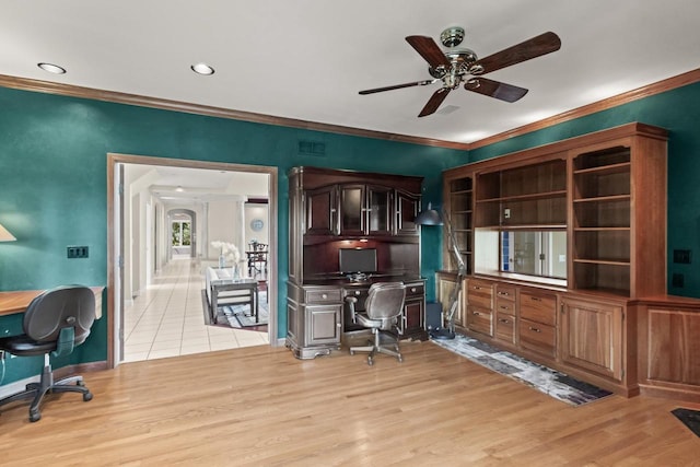 office space featuring ceiling fan, light wood-type flooring, and crown molding