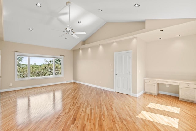 spare room featuring high vaulted ceiling, light wood-type flooring, and ceiling fan