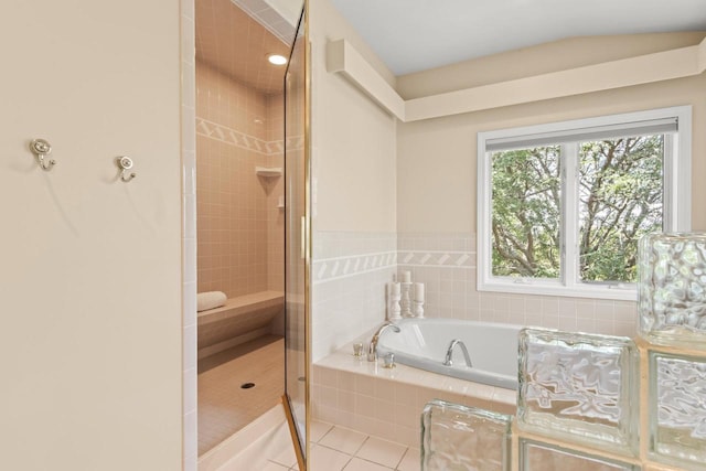 bathroom with separate shower and tub and tile patterned flooring