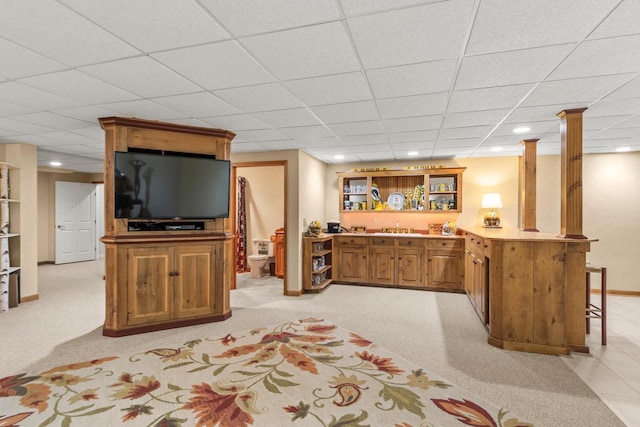 interior space featuring a drop ceiling and bar area