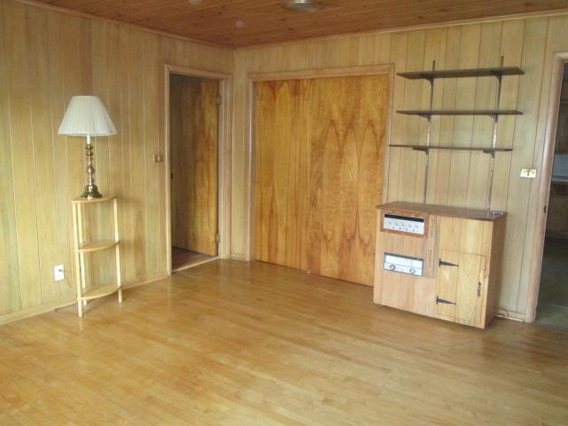 interior space with wood ceiling, wooden walls, and hardwood / wood-style flooring