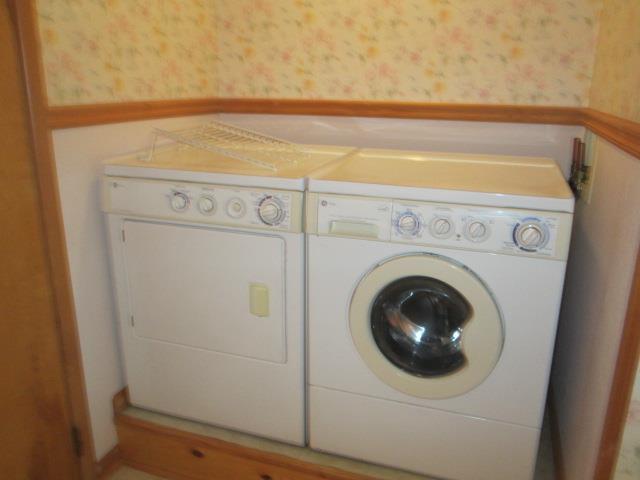 clothes washing area with separate washer and dryer