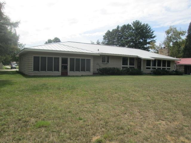 back of house with a lawn