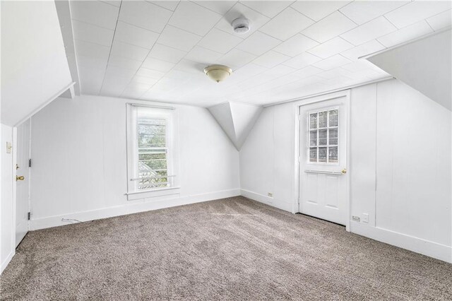 bonus room with carpet floors and vaulted ceiling