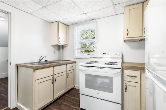 kitchen with dark wood-style flooring, white electric range, a sink, a drop ceiling, and cream cabinets