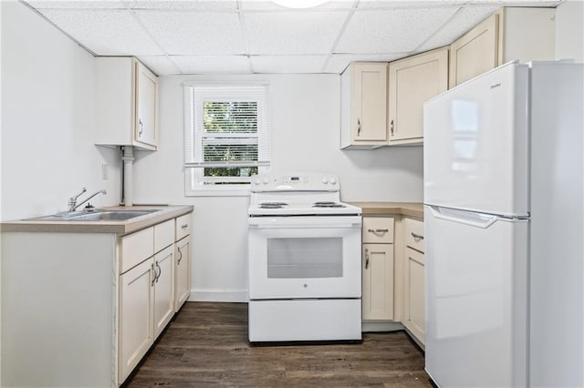 kitchen featuring a paneled ceiling, light countertops, dark wood-style floors, and white appliances