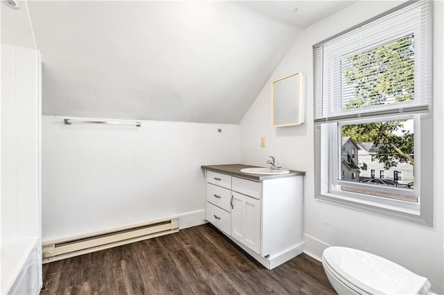 bathroom with a baseboard radiator, wood finished floors, toilet, vanity, and lofted ceiling