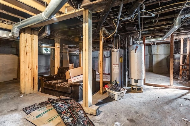 unfinished below grade area with water heater, electric water heater, and heating fuel