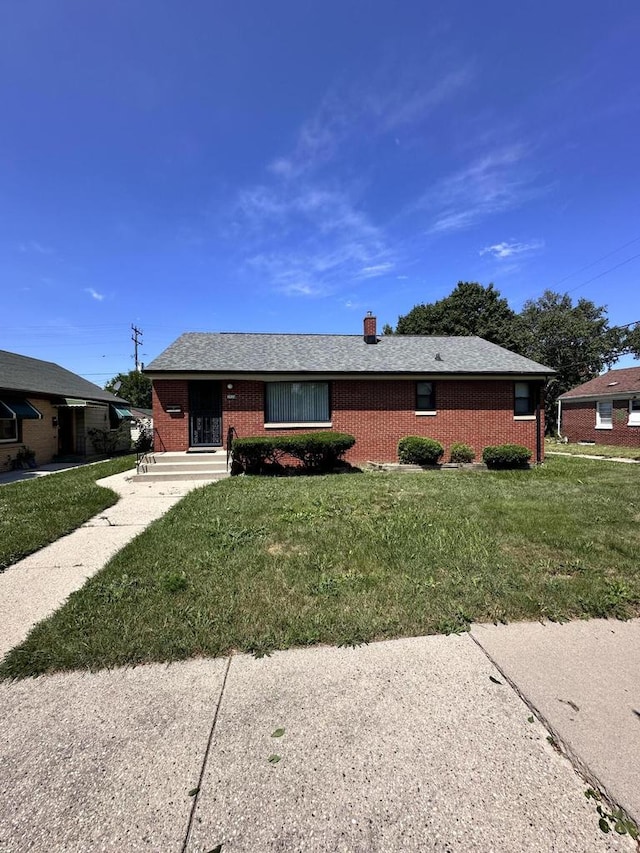 ranch-style home with a front lawn