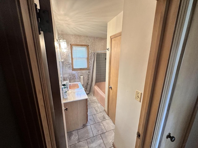 bathroom featuring vanity and shower / bath combo with shower curtain