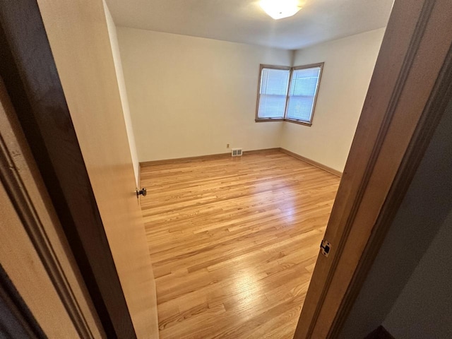 empty room with light hardwood / wood-style floors