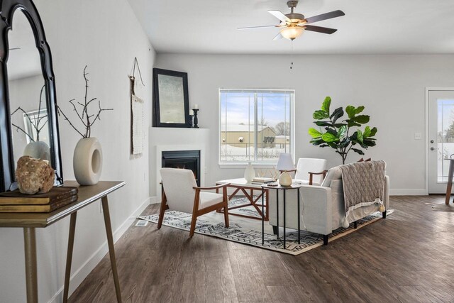 living room featuring dark wood-type flooring and ceiling fan