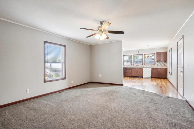 unfurnished living room with crown molding, light hardwood / wood-style flooring, and ceiling fan