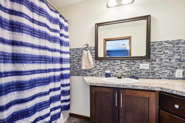 bathroom featuring tasteful backsplash, walk in shower, and vanity