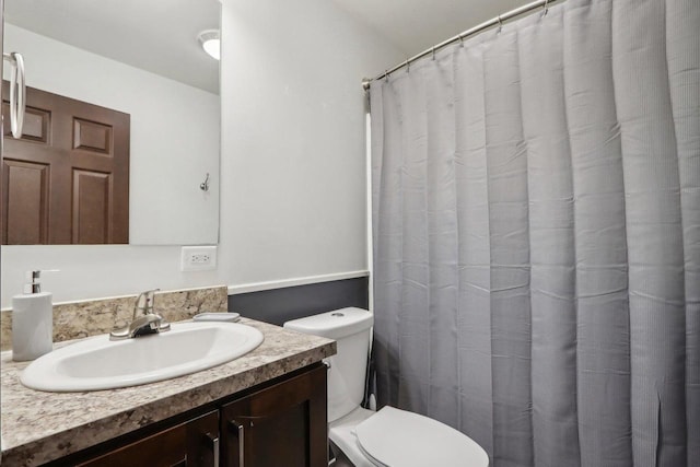 bathroom with vanity, toilet, and a shower with shower curtain