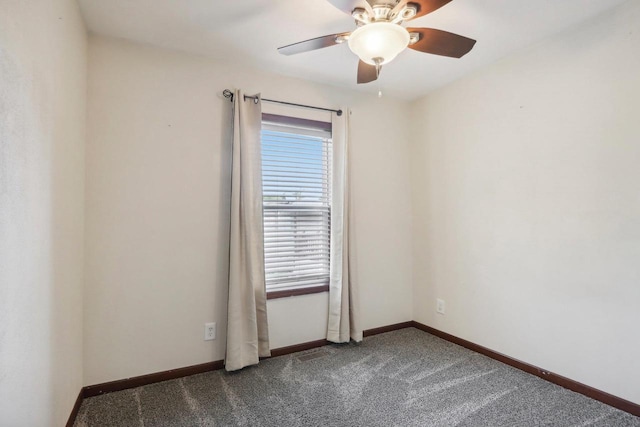 carpeted spare room featuring ceiling fan