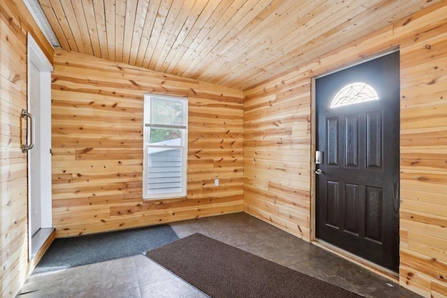 entrance foyer featuring wood walls and wood ceiling