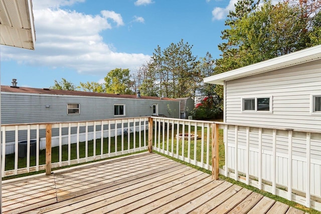 wooden deck with a lawn