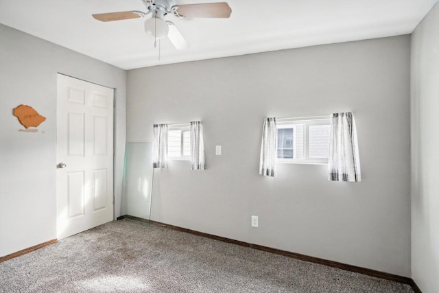 unfurnished room featuring ceiling fan and carpet flooring