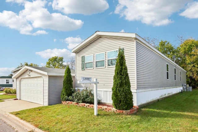 view of property exterior featuring a garage, a lawn, and an outbuilding