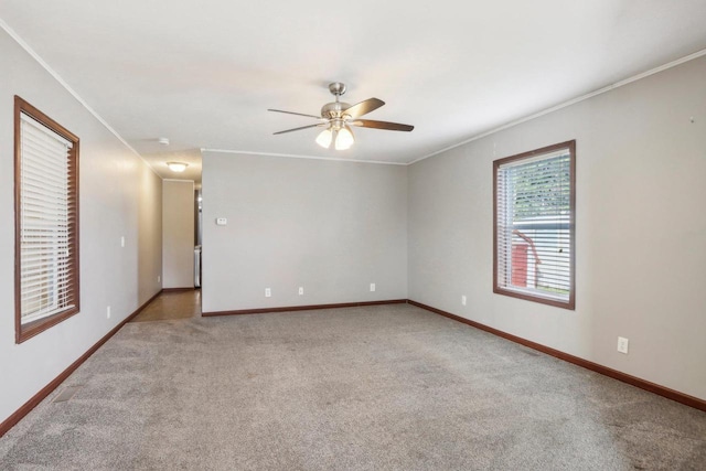 unfurnished room with ornamental molding, ceiling fan, and light colored carpet