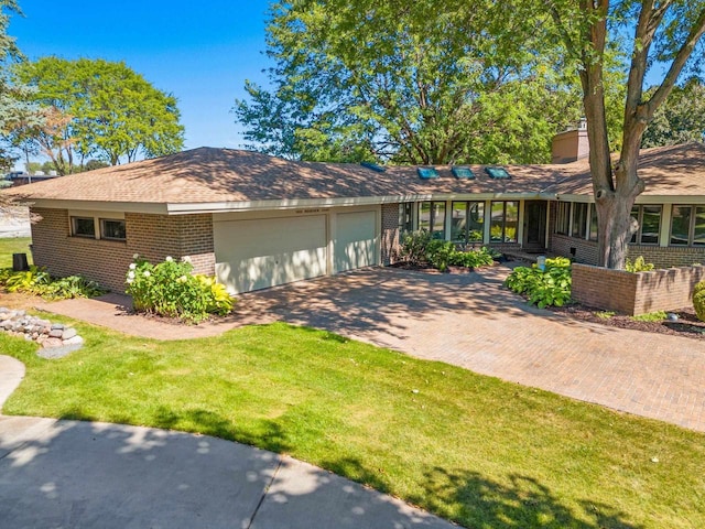 ranch-style home with a garage and a front yard