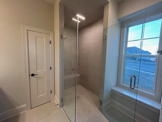 bathroom with a mountain view, tile patterned flooring, and walk in shower