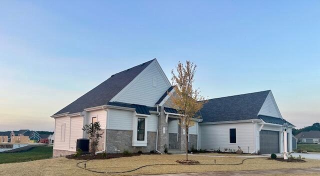 view of front of property with a yard and a garage