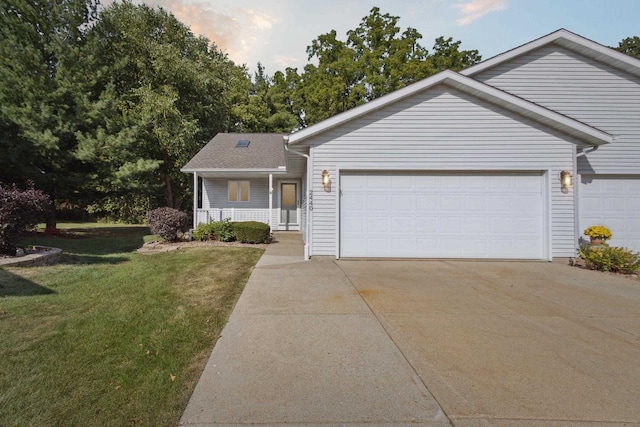 view of front facade featuring a yard, a garage, and a porch