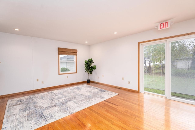 empty room with light hardwood / wood-style flooring