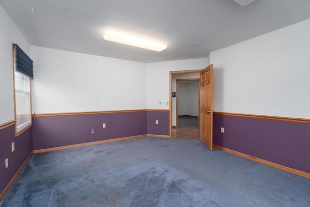 empty room with dark colored carpet