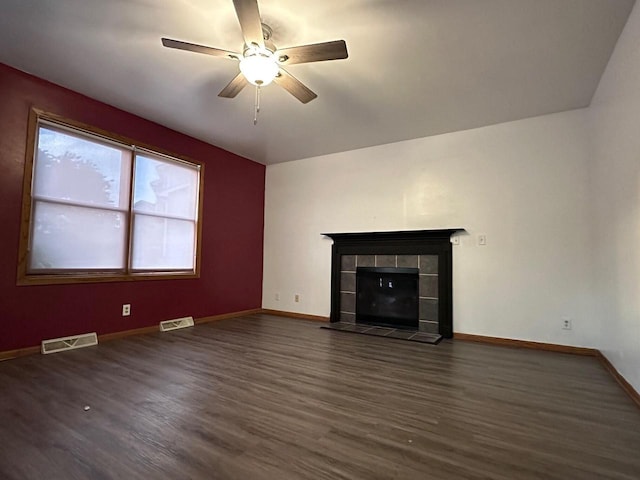 unfurnished living room with ceiling fan, dark hardwood / wood-style floors, and a fireplace