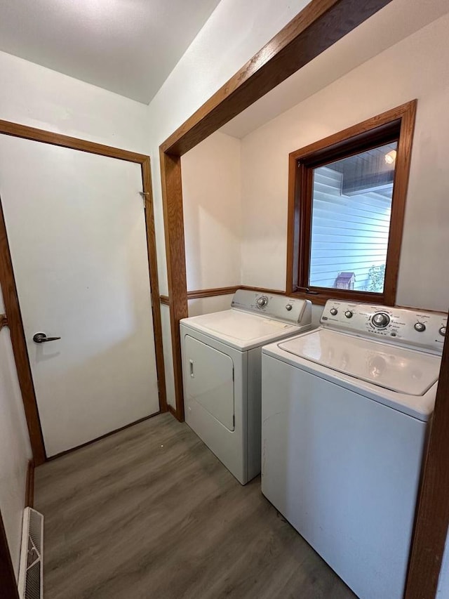 laundry area featuring dark hardwood / wood-style flooring and washing machine and clothes dryer