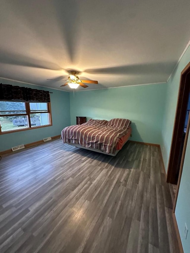 bedroom featuring ceiling fan and dark hardwood / wood-style floors