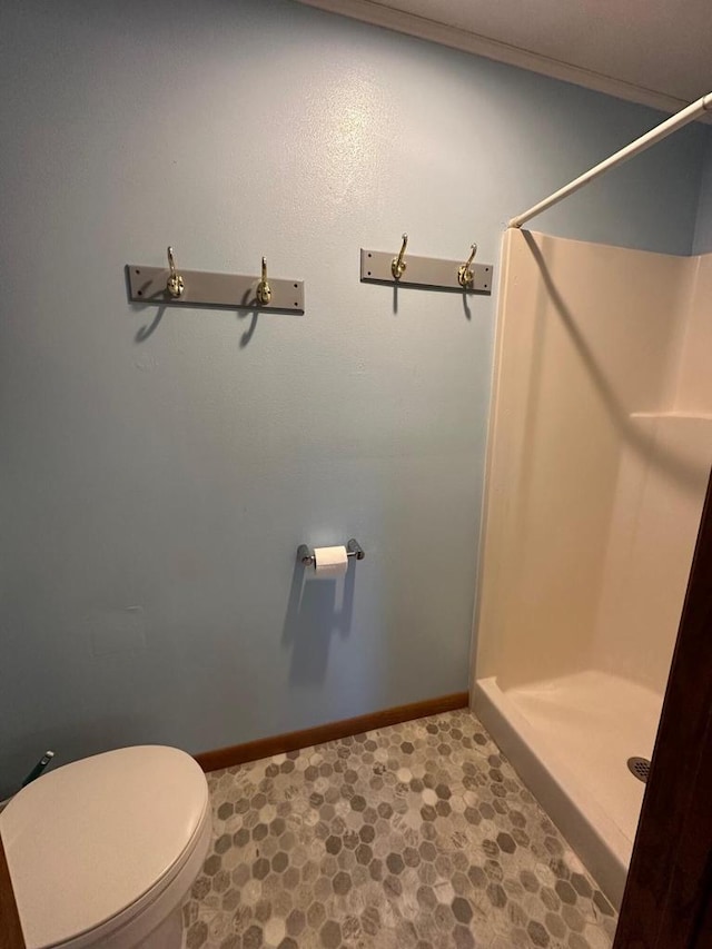 bathroom with walk in shower, tile patterned floors, and toilet